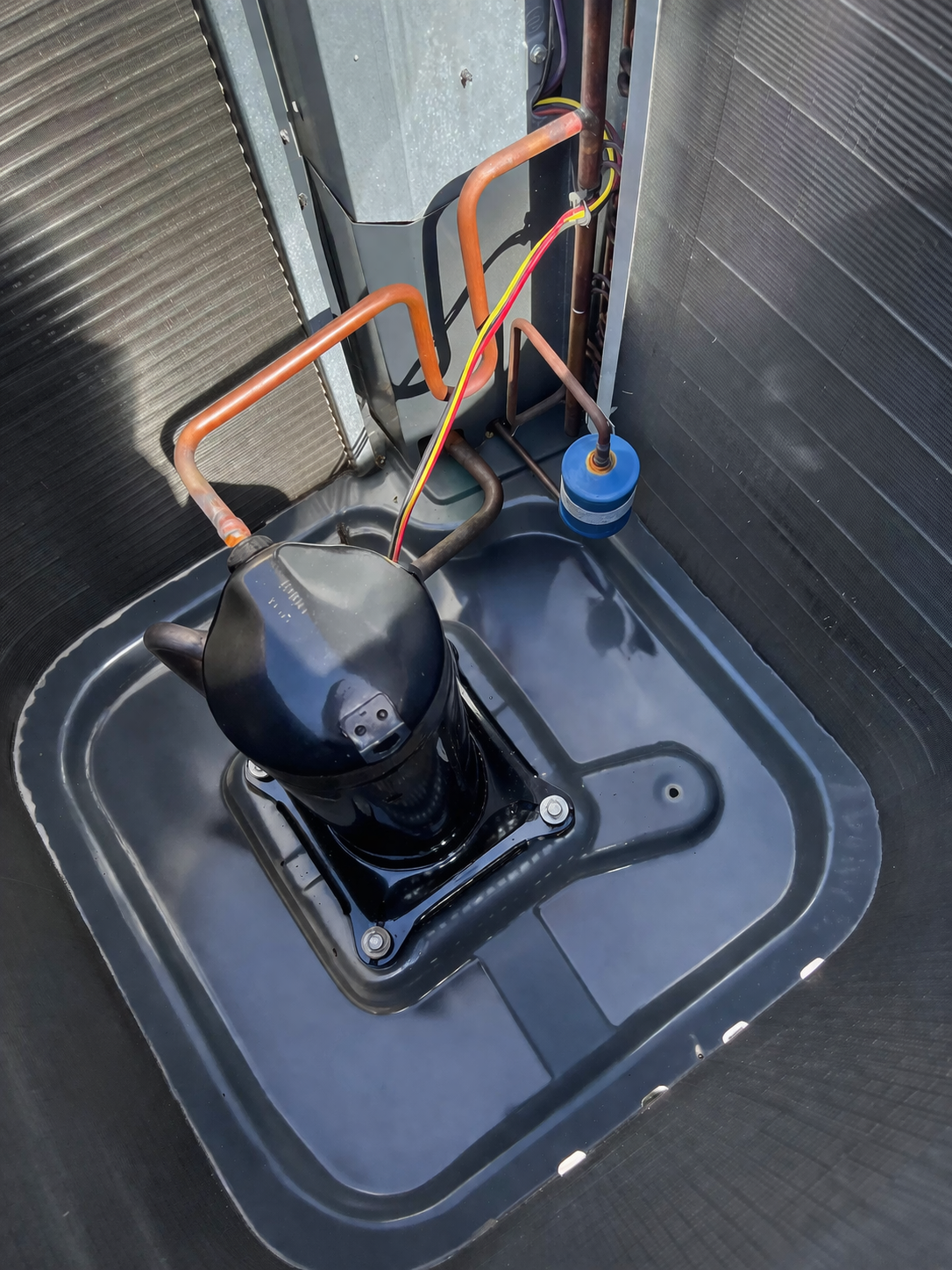 Inside an outdoor AC unit after inspection